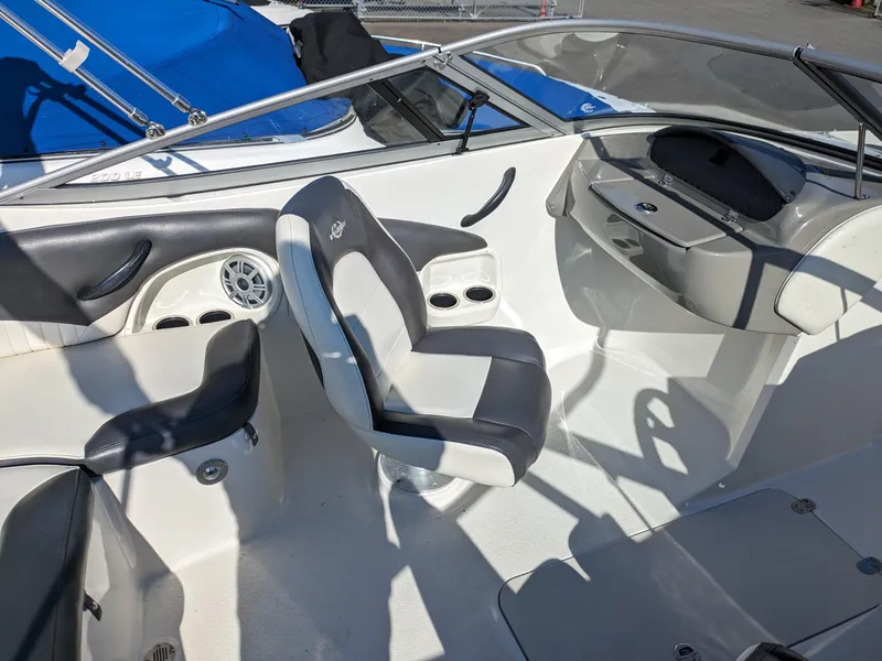 Slide: The Image of 2018 Stingray 208 LS boat interior with seating and dashboard. - 15