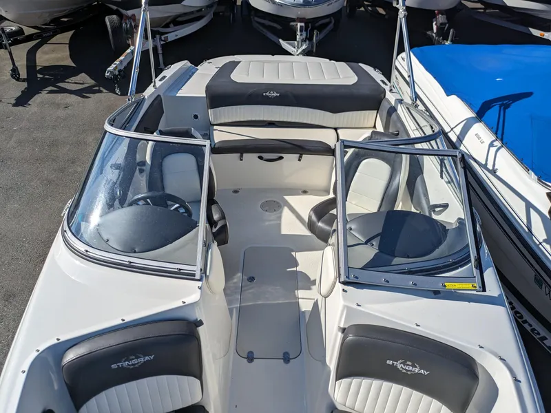 Slide: The Image of 2018 Stingray 208 LS boat interior with seating and steering wheel. - 20