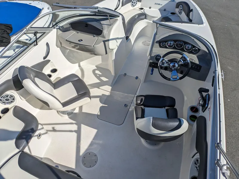 Slide: The Image of 2018 Stingray 208 LS boat interior with steering wheel and seating arrangement. - 21