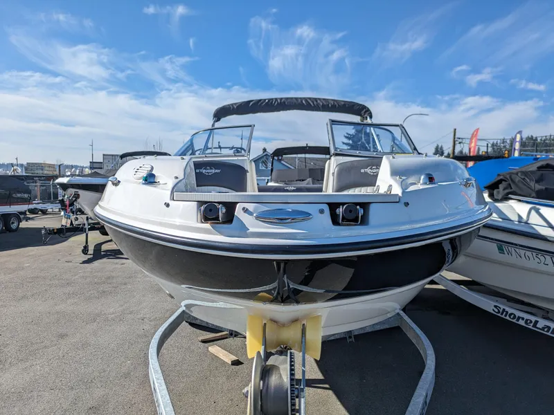 Slide: The Image of 2018 Stingray 208 LS boat on trailer under clear blue sky. - 24