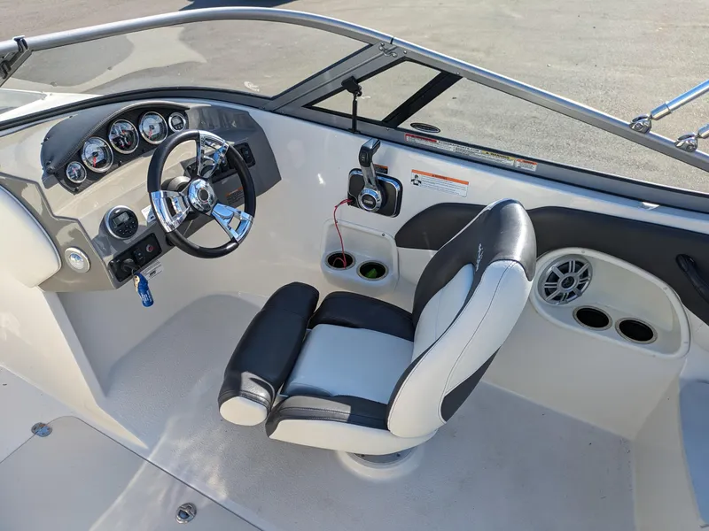 Slide: The Image of 2018 Stingray 208 LS boat interior with steering wheel and seating. - 7