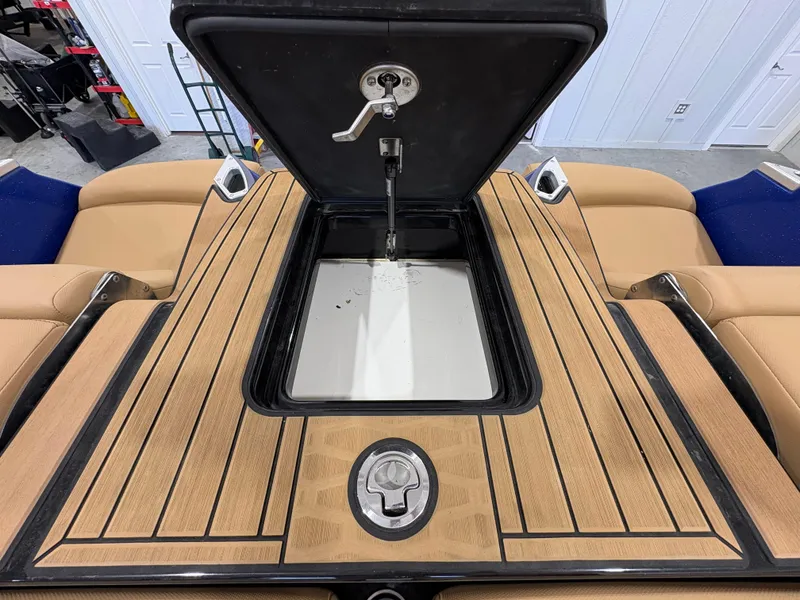 Slide: The Image of 2022 MasterCraft X26 boat interior with tan leather seating and stylish flooring. - 12