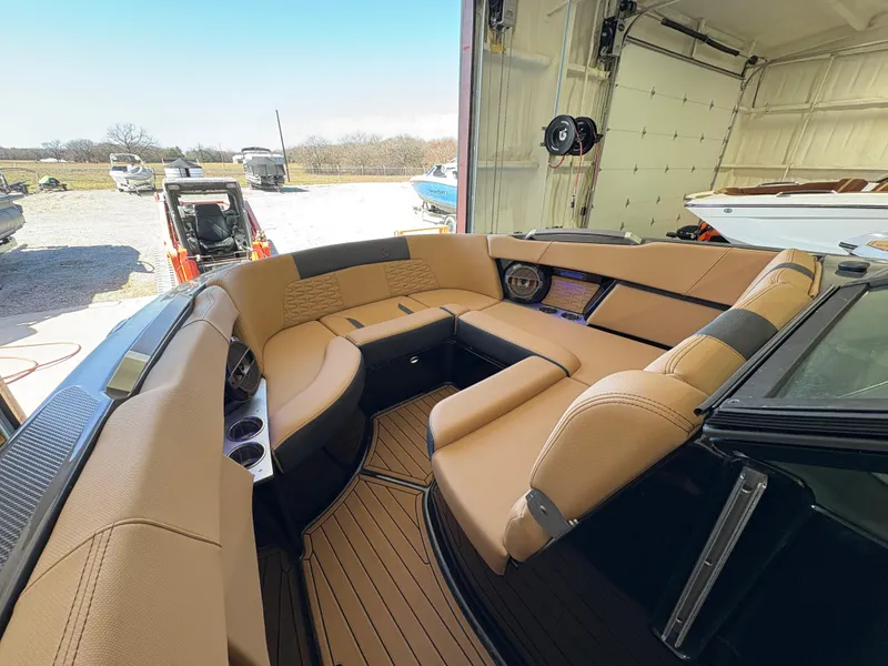 Slide: The Image of 2022 MasterCraft X26 boat interior with luxurious tan seating and modern design. - 15