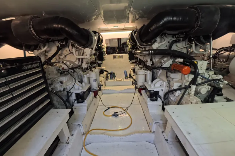 Slide: The Image of Engine room of a 2012 Custom Sportfish boat with dual engines and tool storage. - 11