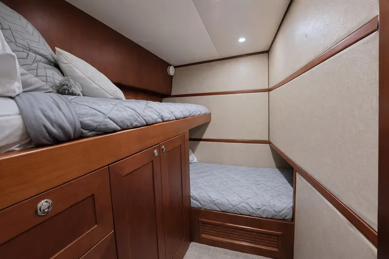 Slide: The Image of Luxurious 2012 Custom Sportfish yacht cabin with cozy bunk beds and elegant wood finish. - 8