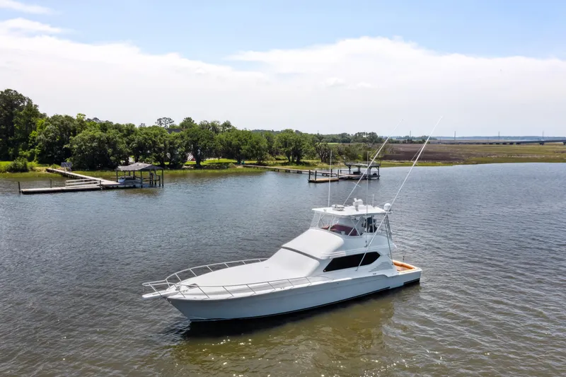 The Image of Custom 2012 Sportfish boat on water with bridge and cargo ship in background. - 0