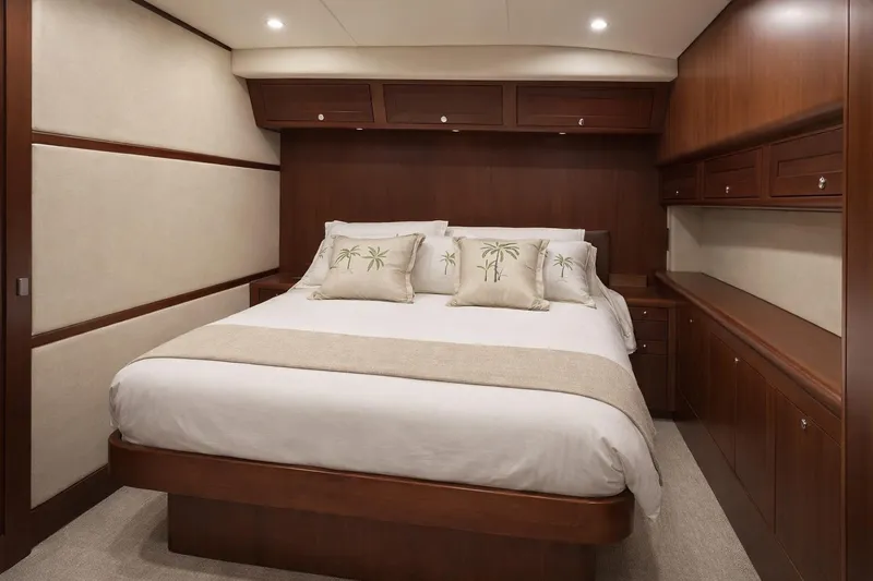 Slide: The Image of Luxurious 2012 Custom Sportfish yacht bedroom with elegant wood cabinetry and plush bedding. - 6