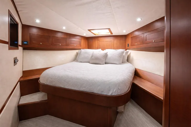 Slide: The Image of Luxurious cabin interior of 2012 Custom Sportfish yacht with cozy bed and wooden accents. - 9