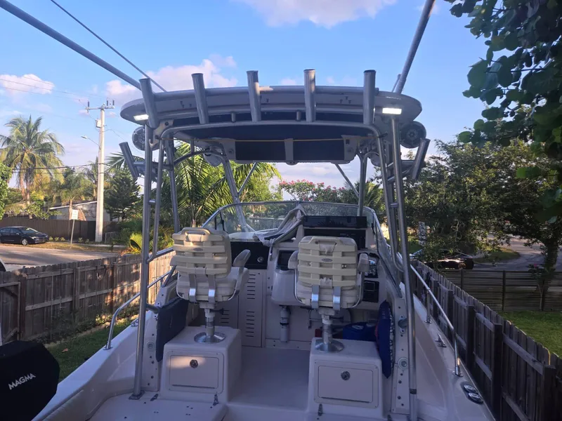 Slide: The Image of 2001 Grady-White Sailfish 282 boat with dual seats and canopy, parked outdoors. - 2