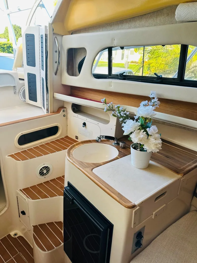 Slide: The Image of 2001 Grady-White Sailfish 282 cabin interior with sink, flowers, and wooden accents. - 4