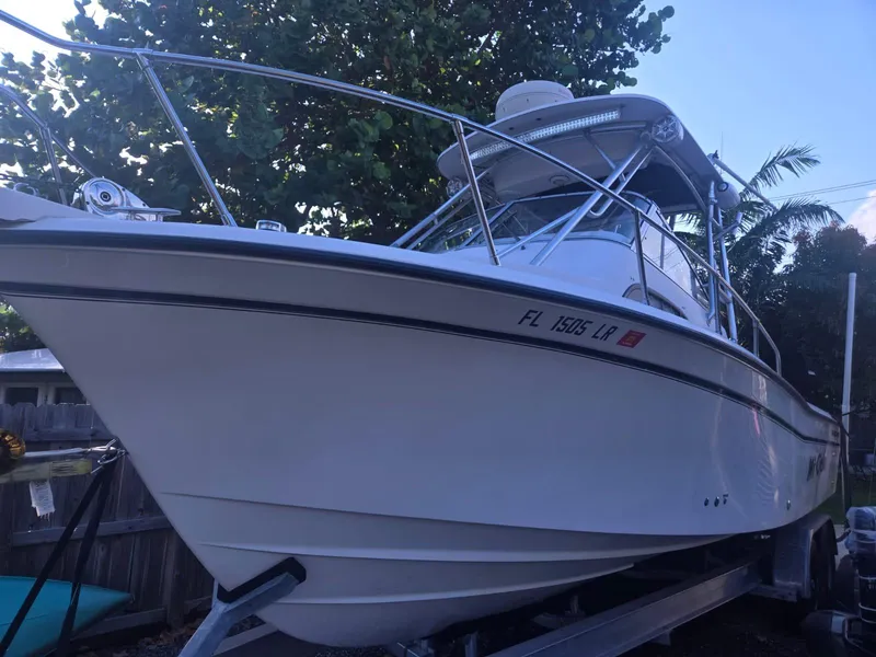 Slide: The Image of 2001 Grady-White Sailfish 282 boat on trailer, surrounded by trees. - 6
