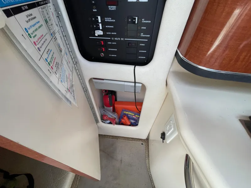 Slide: The Image of Interior view of a 2004 Sea Ray 260 Sundancer boat, showing control panel and storage area. - 12