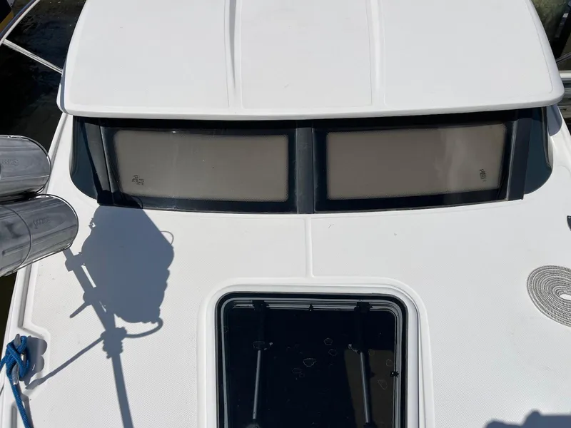 Slide: The Image of 2010 Regal 2565 Window Express boat deck with windows and hatch. - 10