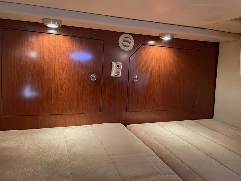 Slide: The Image of 2010 Regal 2565 Window Express cabin interior with wood paneling and cozy lighting. - 23