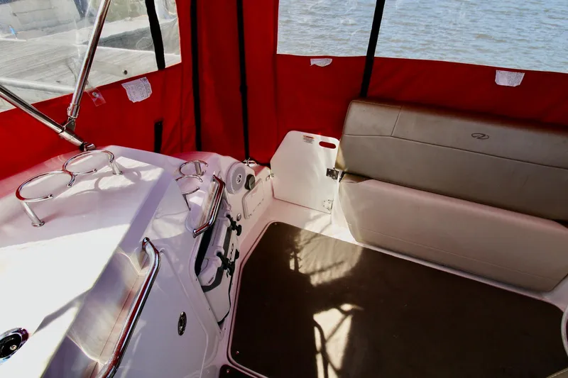 Slide: The Image of Interior of 2010 Regal 2565 Window Express boat with red canopy and seating. - 6