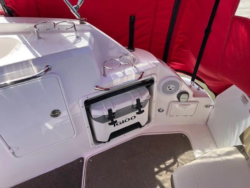 Slide: The Image of 2010 Regal 2565 Window Express boat interior with cooler and red canopy. - 9