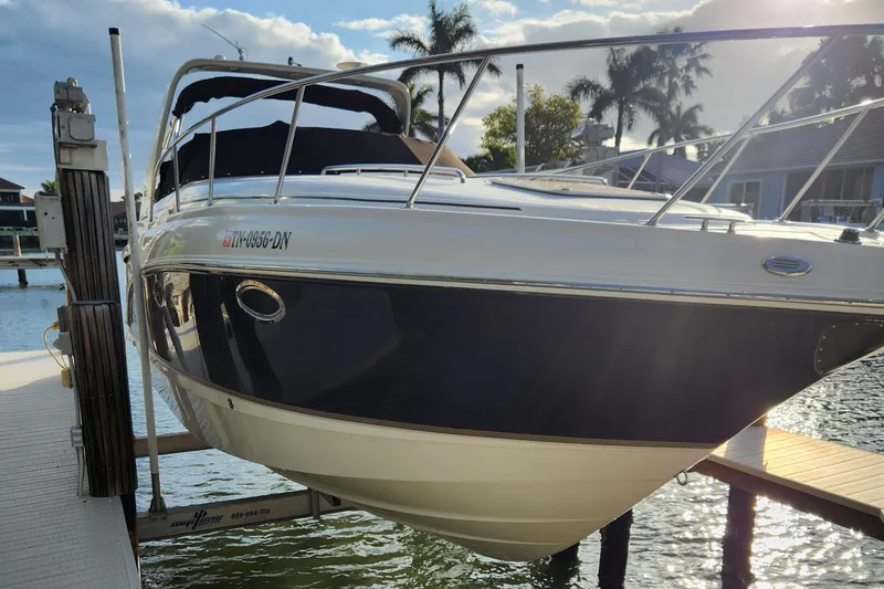 Slide: The Image of 2004 Chaparral Signature 290 boat docked, with sleek design and sunny backdrop. - 1