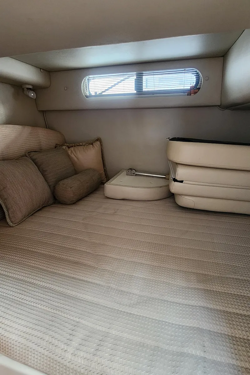 Slide: The Image of 2004 Chaparral Signature 290 cabin interior with bed and cushions. - 11