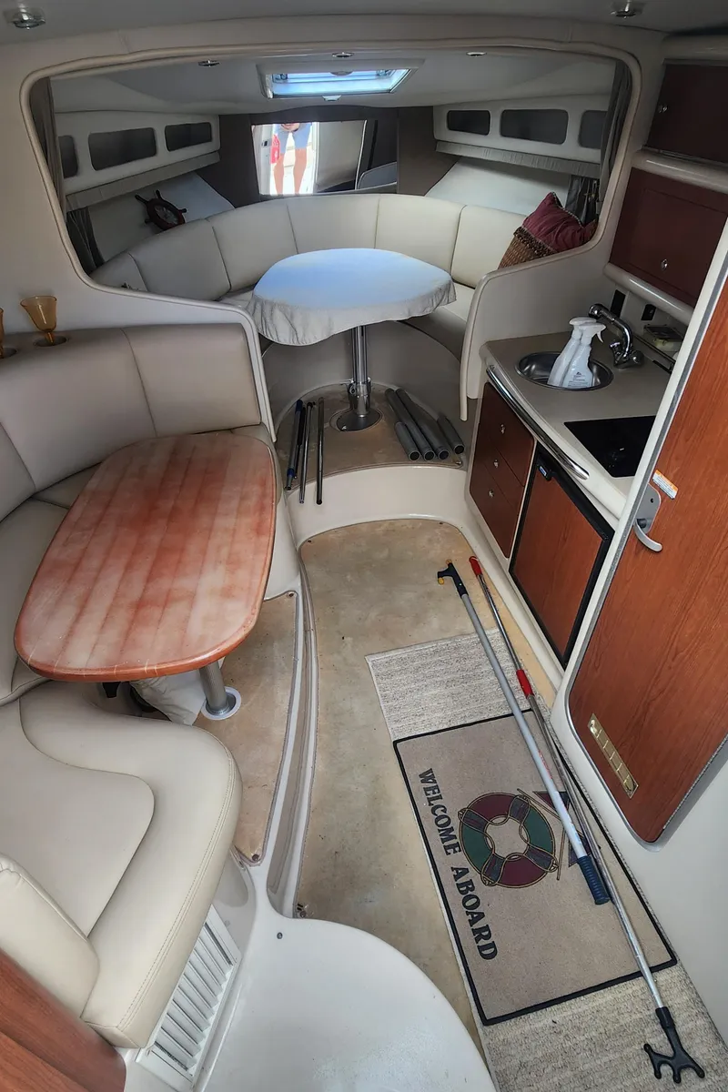 Slide: The Image of Interior of a 2004 Chaparral Signature 290 boat with seating and kitchenette. - 13