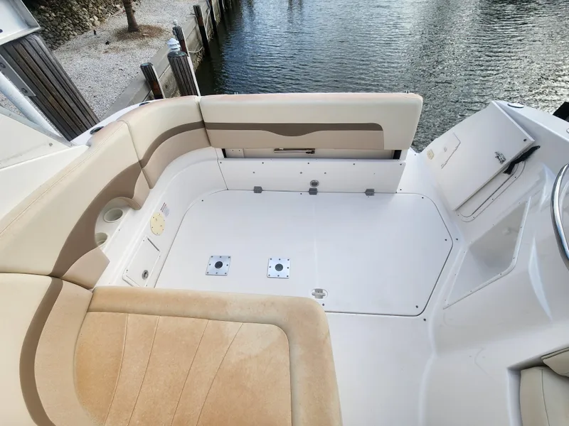 Slide: The Image of 2004 Chaparral Signature 290 boat interior with beige seating and water view. - 4