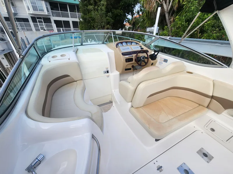 Slide: The Image of 2004 Chaparral Signature 290 boat interior with beige seating and control panel. - 5
