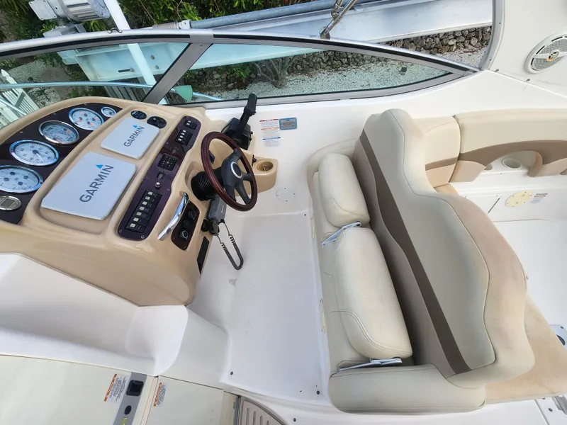 Slide: The Image of 2004 Chaparral Signature 290 helm with Garmin navigation and beige seating. - 6