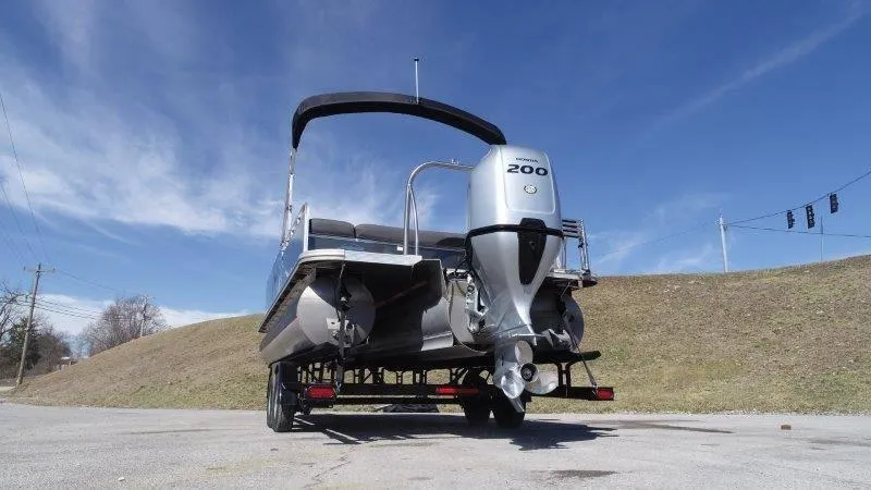Slide: The Image of 2022 Tahoe LTZ VRB 2485 pontoon boat with powerful outboard motor, parked on a sunny day. - 11