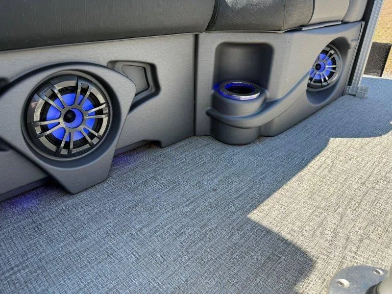 Slide: The Image of Interior of 2022 Tahoe LTZ VRB 2485 with blue-lit speakers and cup holders. - 12