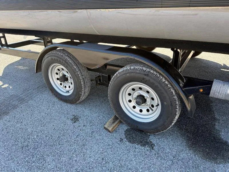Slide: The Image of Trailer wheels of a 2022 Tahoe LTZ VRB 2485 on asphalt. - 24
