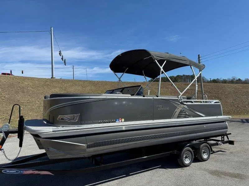 Slide: The Image of 2022 Tahoe LTZ VRB 2485 pontoon boat on trailer, under clear blue sky. - 27