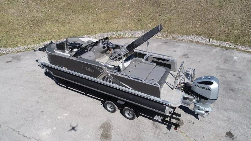 Slide: The Image of 2022 Tahoe LTZ VRB 2485 pontoon boat on trailer with Honda outboard motor. - 3