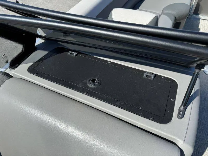 Slide: The Image of 2022 Tahoe LTZ VRB 2485 boat storage compartment with black cover and hydraulic supports. - 36