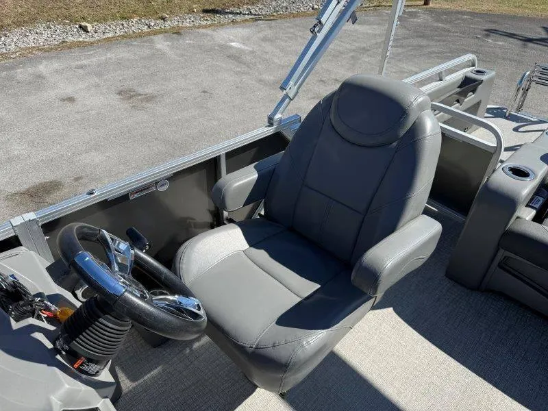 Slide: The Image of 2022 Tahoe LTZ VRB 2485 boat interior with gray captain's chair and steering wheel. - 40