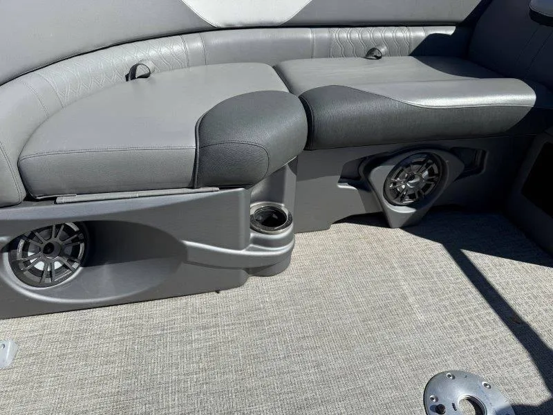 Slide: The Image of 2022 Tahoe LTZ VRB 2485 boat interior with gray seating and built-in speakers. - 43