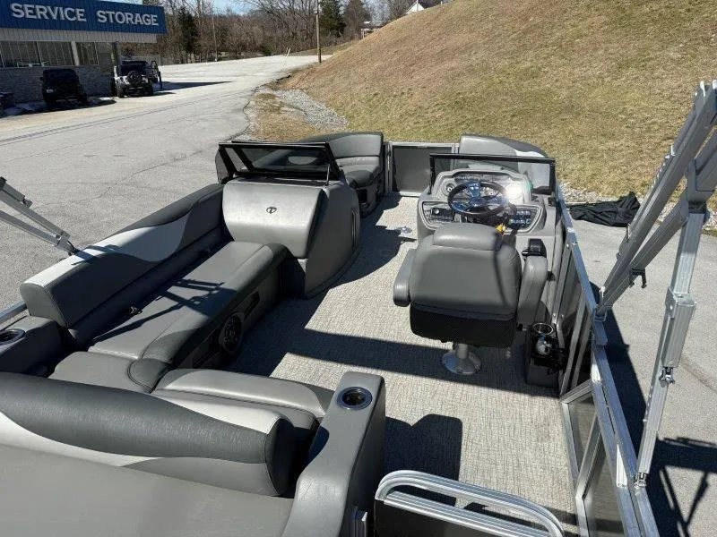 Slide: The Image of 2022 Tahoe LTZ VRB 2485 pontoon boat interior with gray seating and steering console. - 46