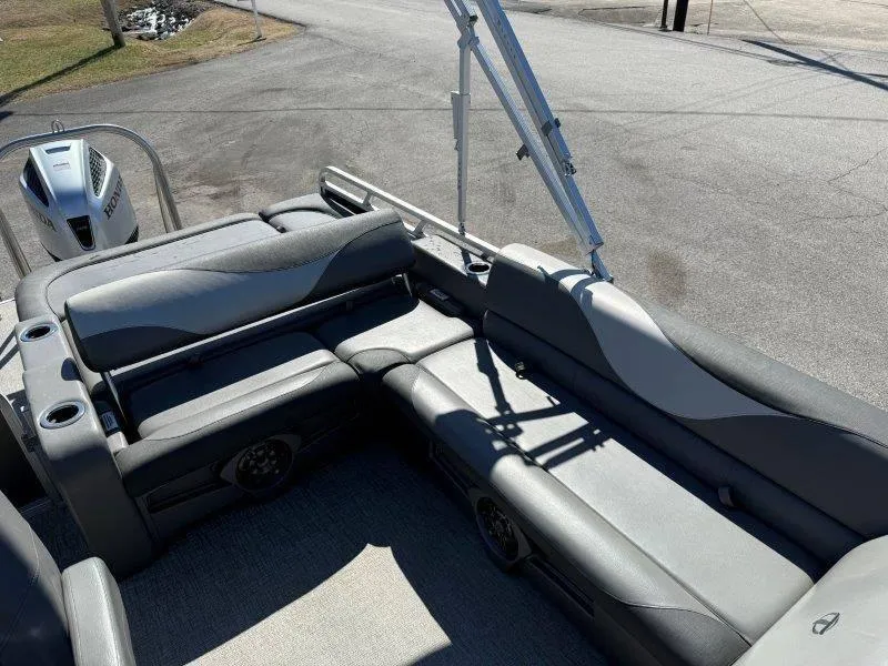 Slide: The Image of 2022 Tahoe LTZ VRB 2485 pontoon boat with gray seating and Honda outboard motor. - 49