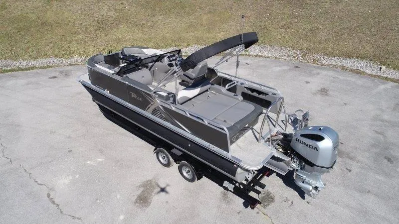 Slide: The Image of 2022 Tahoe LTZ VRB 2485 pontoon boat with Honda outboard motor on trailer. - 6