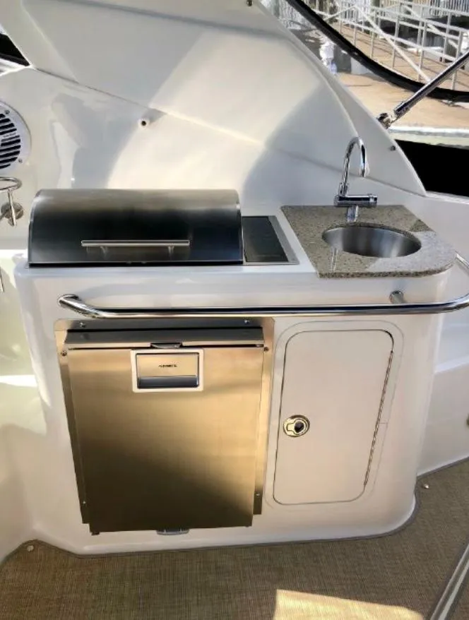 Slide: The Image of 2017 Sea Ray Sundancer 280 boat kitchenette with grill, sink, and storage. - 4