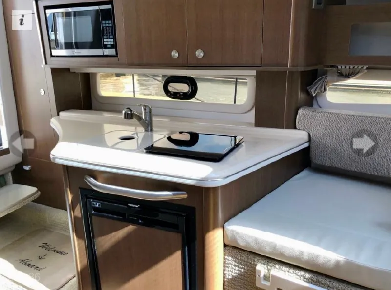 Slide: The Image of Interior of 2017 Sea Ray Sundancer 280 with kitchenette and seating area. - 6