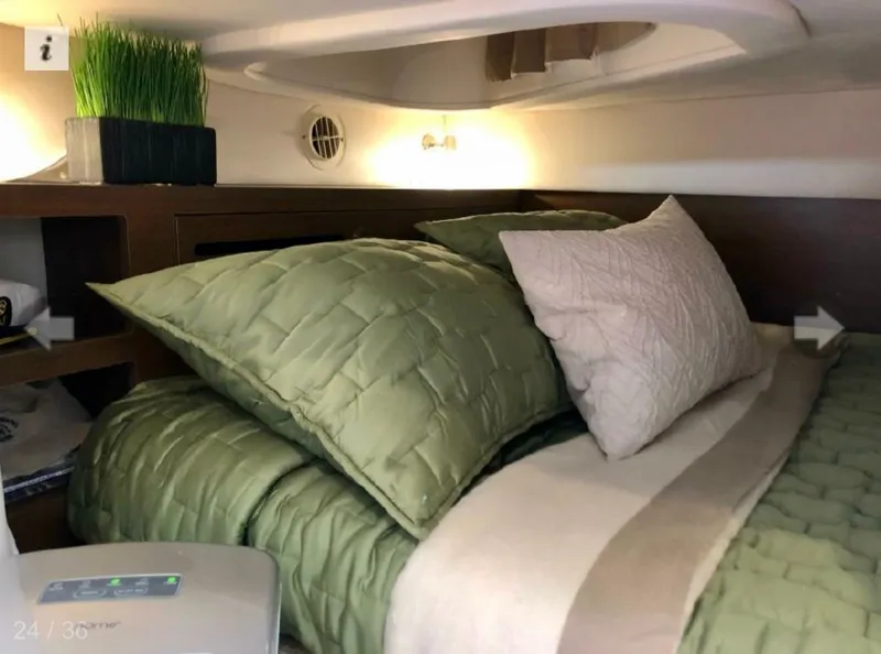 Slide: The Image of Cozy cabin interior of 2017 Sea Ray Sundancer 280 with green bedding and modern decor. - 7