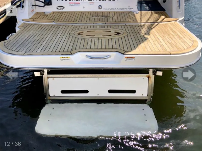 Slide: The Image of 2017 Sea Ray Sundancer 280 swim platform on water, showcasing teak decking. - 8