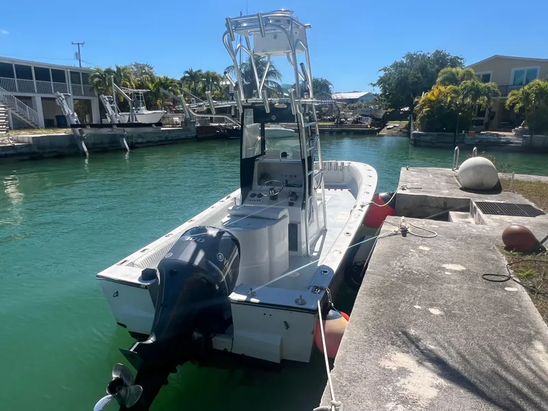 Slide: The Image of 1984 SeaVee 25 boat docked in a sunny canal setting. - 1