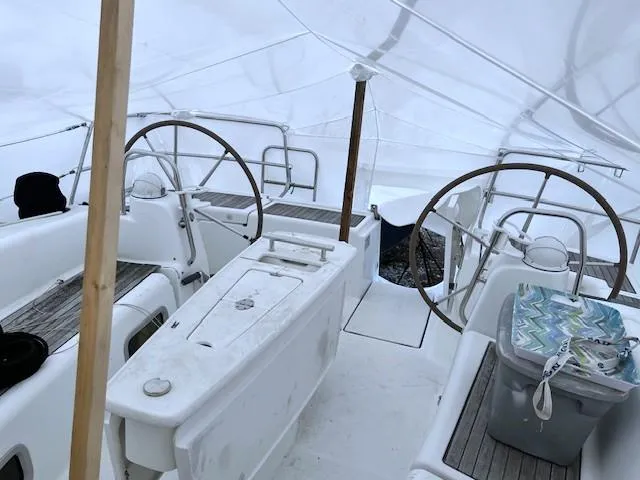 Slide: The Image of 2007 Beneteau Oceanis 46 yacht cockpit under protective cover, featuring dual steering wheels. - 12