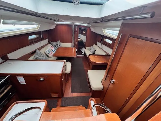 Slide: The Image of Interior of 2007 Beneteau Oceanis 46 sailboat with wood finish and cozy seating area. - 17