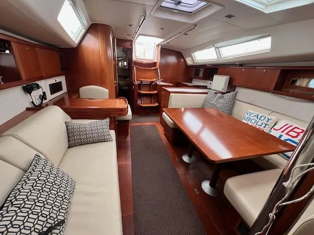 Slide: The Image of Interior of 2007 Beneteau Oceanis 46 sailboat with wood finish and comfortable seating. - 18