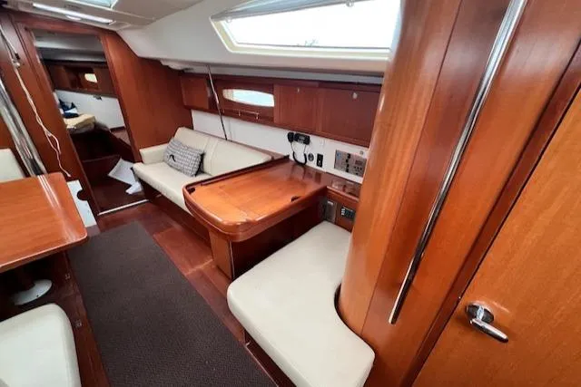 Slide: The Image of Interior of 2007 Beneteau Oceanis 46 sailboat with wooden furnishings and seating area. - 19