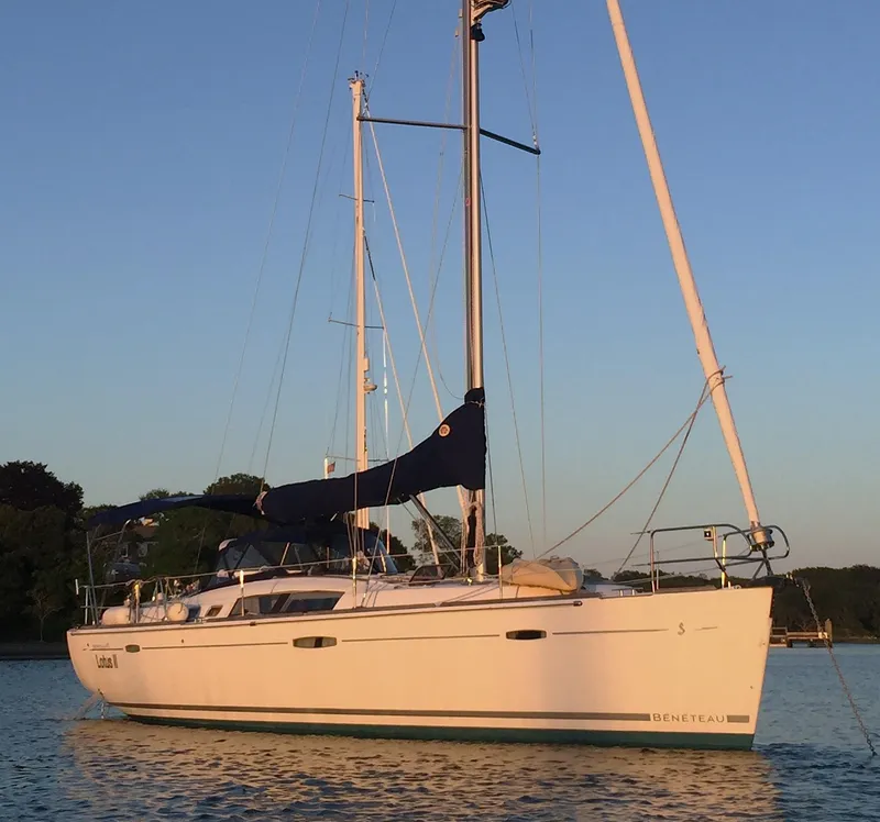 Slide: The Image of 2007 Beneteau Oceanis 46 sailboat on calm water at sunset. - 2