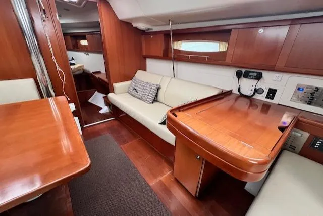 Slide: The Image of Interior of 2007 Beneteau Oceanis 46 yacht with wooden furnishings and cozy seating area. - 20