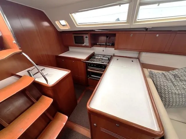 Slide: The Image of Interior of 2007 Beneteau Oceanis 46 yacht with modern kitchen and wooden cabinetry. - 22