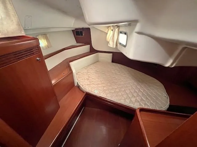 Slide: The Image of 2007 Beneteau Oceanis 46 cabin with wooden interior and cozy bed. - 25